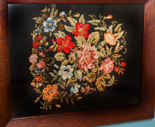 Framed needlework by Elizabeth Payne.
